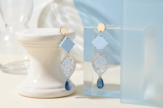 Blue Fien long geometric drop earrings in a styled product setting