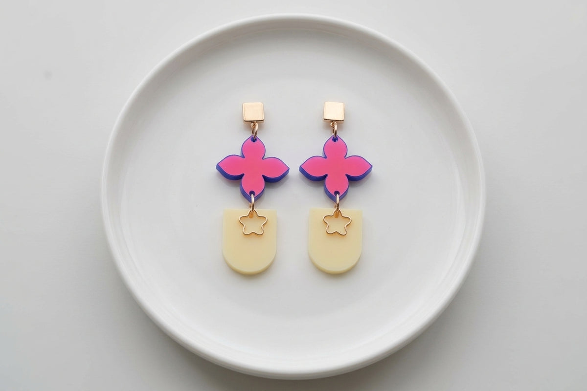 HB Lia floral heart drop earrings arranged on a white plate