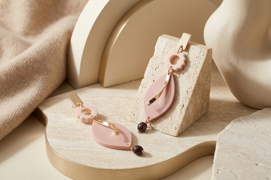Beige Nia long geometric statement earrings in a styled product setting