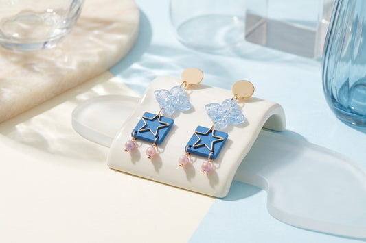 Blue Rose floral star drop earrings in a styled product setting