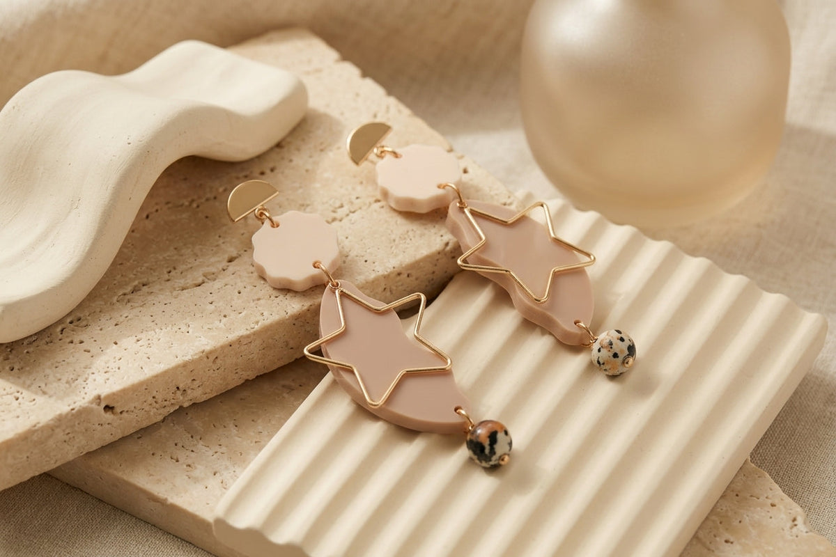 Beige Sara long star dangle earrings in a styled product setting