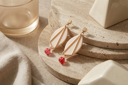 Beige Ada geometric acrylic statement earrings in a styled product setting