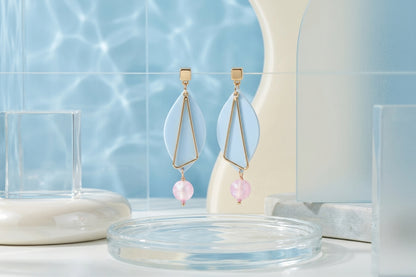 Blue Ada geometric acrylic statement earrings in a styled product setting