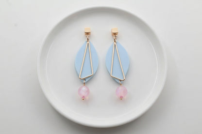 Blue Ada geometric acrylic statement earrings arranged on a white plate