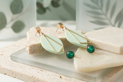 Green Ada geometric acrylic statement earrings in a styled product setting