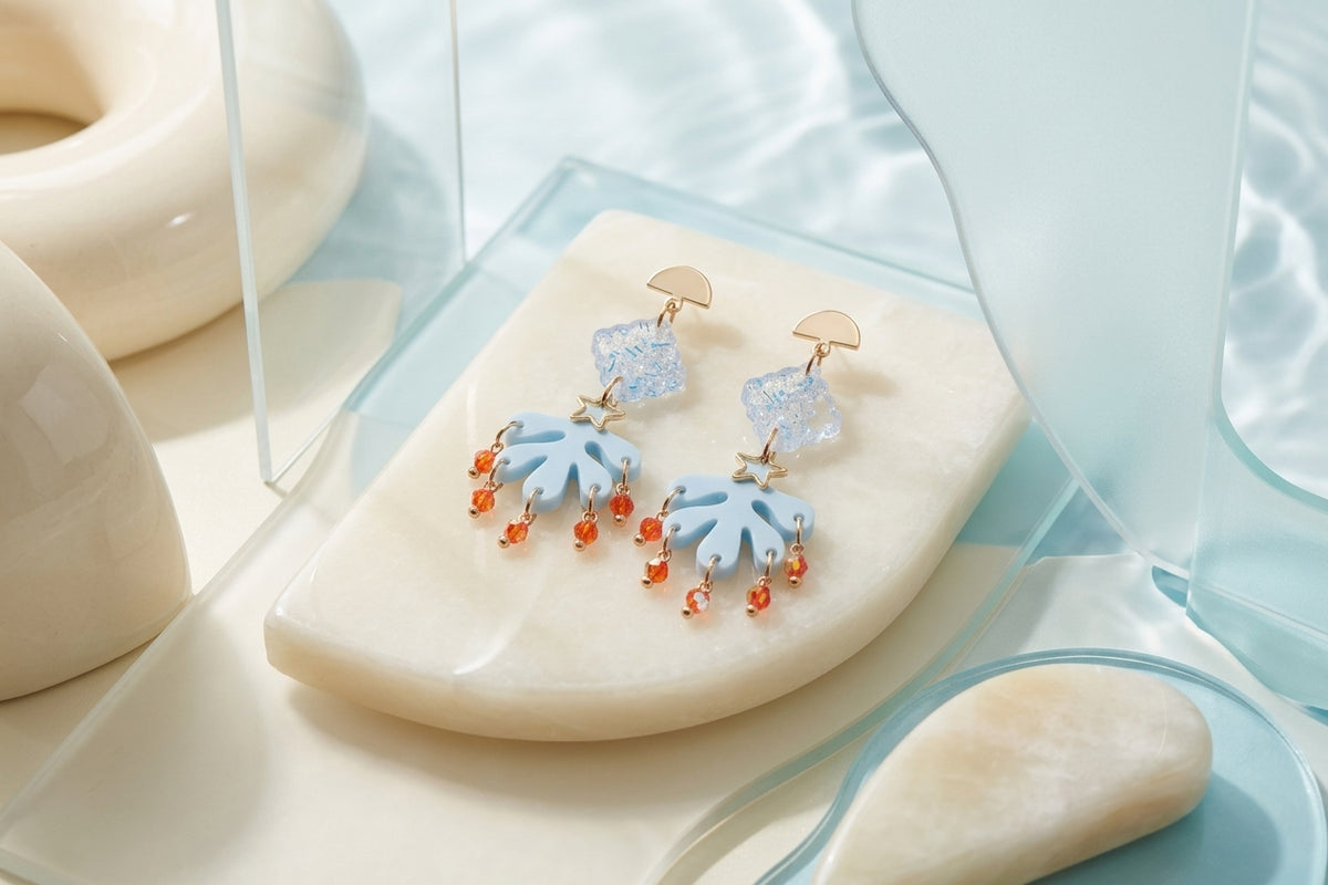Blue Alba acrylic statement dangle earrings in a styled product setting