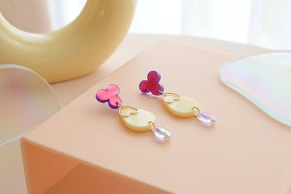 HB Ana teardrop acrylic dangle earrings in a styled product setting