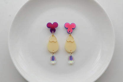 HB Ana teardrop acrylic dangle earrings arranged on a white plate
