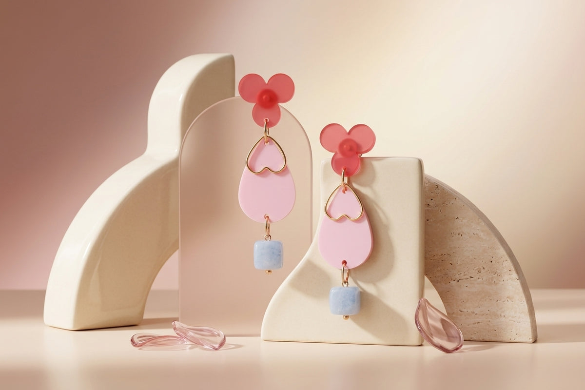 Pink Ana teardrop acrylic dangle earrings in a styled product setting