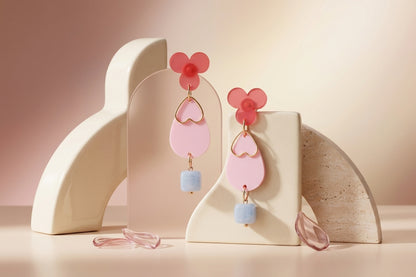 Pink Ana teardrop acrylic dangle earrings in a styled product setting