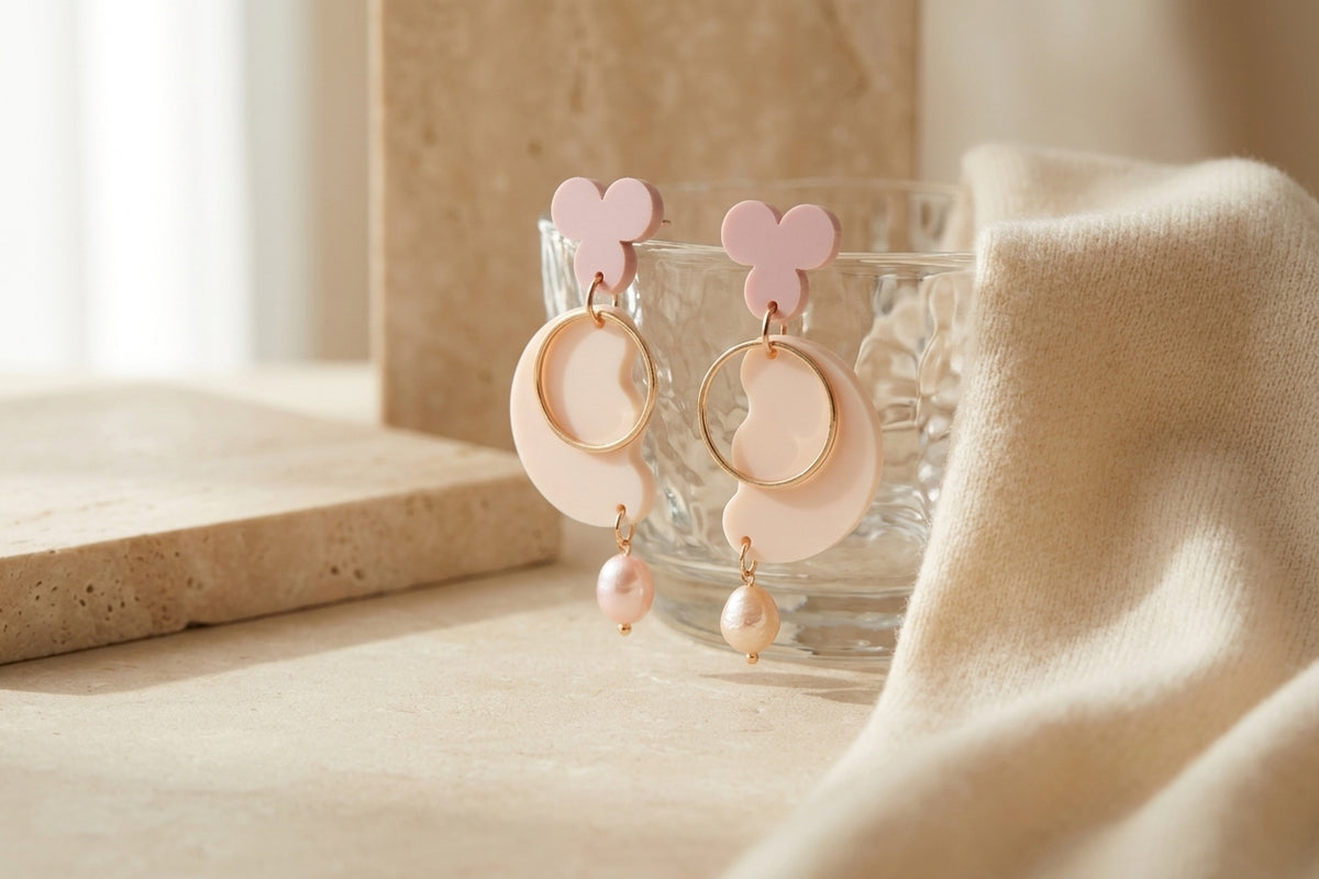 Beige Ayla modern acrylic statement earrings in a styled product setting