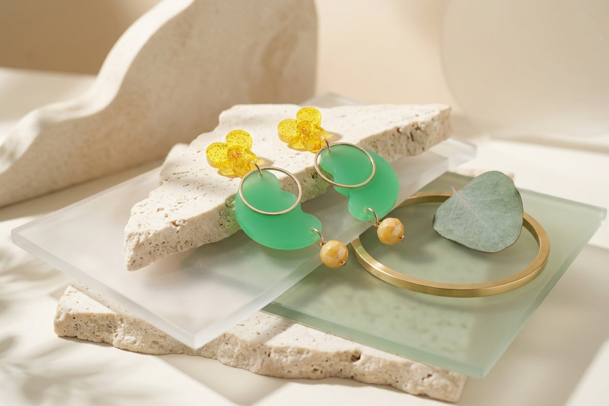 Green Ayla modern acrylic statement earrings in a styled product setting
