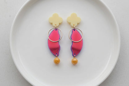 HB Ayla modern acrylic statement earrings arranged on a white plate