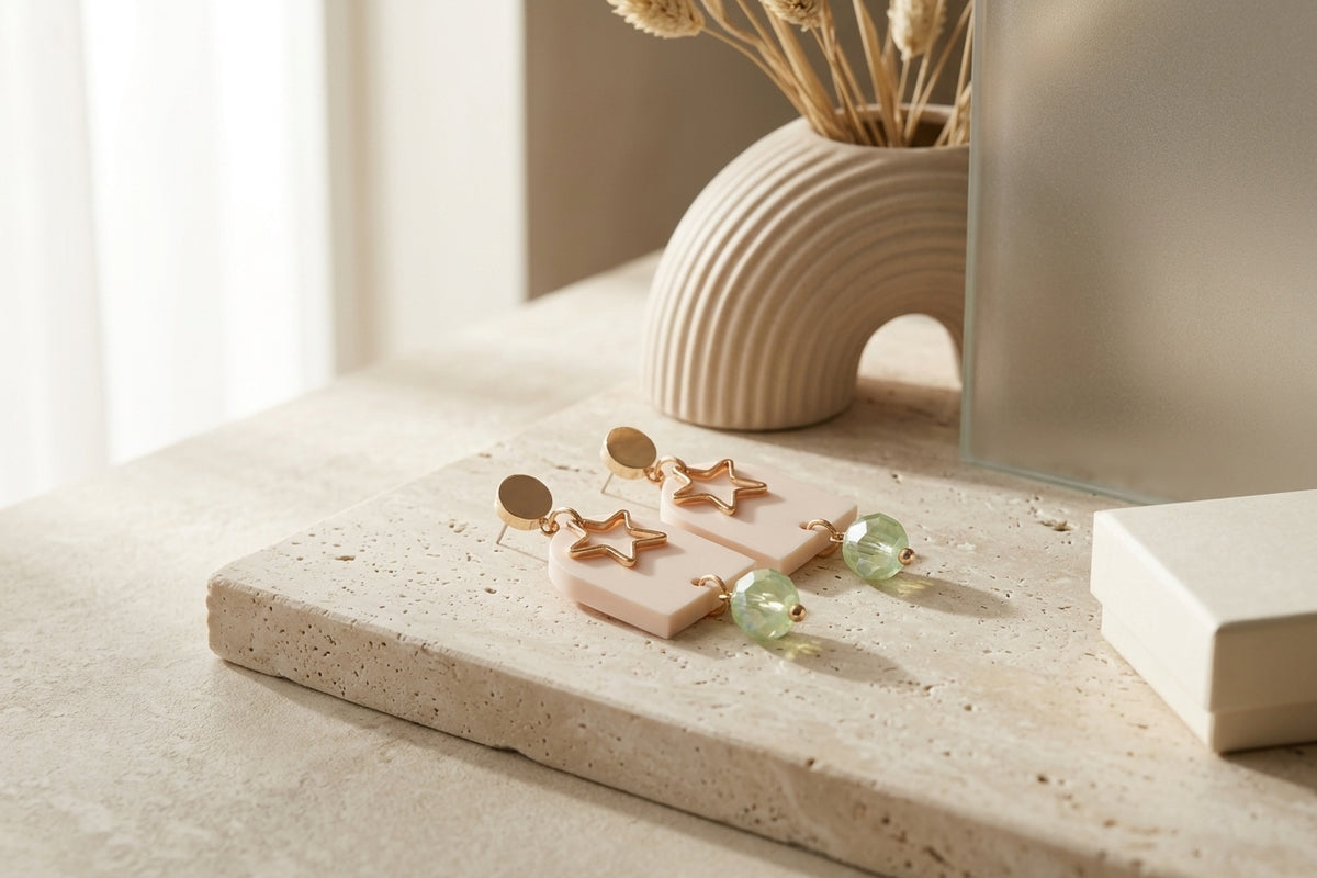 Beige Eira star acrylic drop earrings in a styled product setting