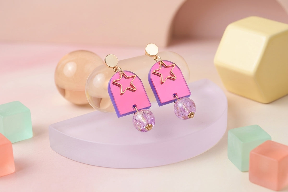 HB Eira star acrylic drop earrings in a styled product setting