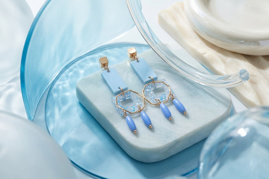 Blue Ella geometric rectangle drop earrings in a styled product setting