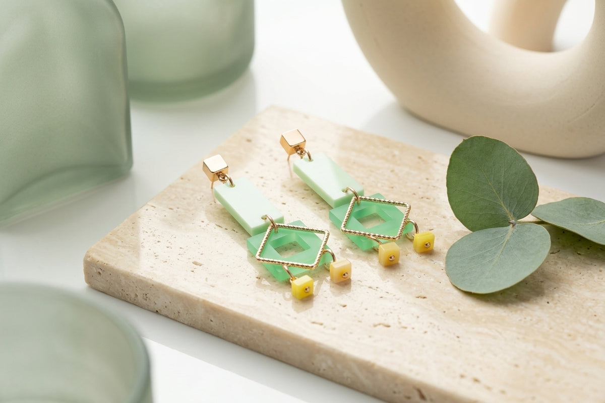 Green Ella geometric rectangle drop earrings in a styled product setting