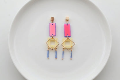 HB Ella geometric rectangle drop earrings arranged on a white plate