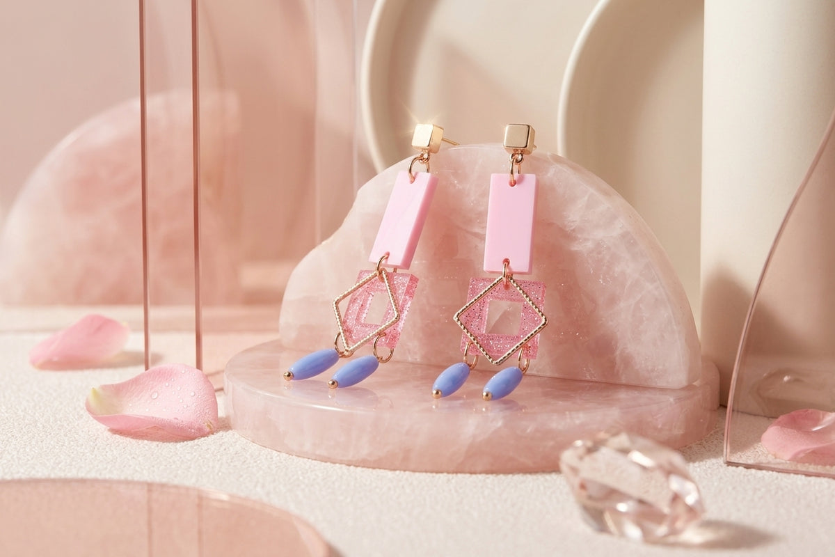 Pink Ella geometric rectangle drop earrings in a styled product setting