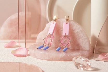 Pink Ella geometric rectangle drop earrings in a styled product setting
