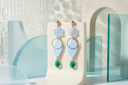 Blue Elsa floral long dangle earrings in a styled product setting