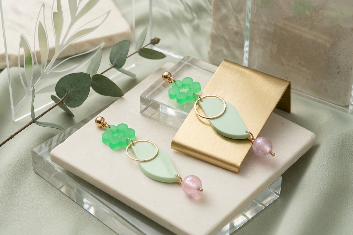 Green Elsa floral long dangle earrings in a styled product setting