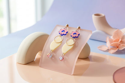 HB Elsa floral long dangle earrings in a styled product setting