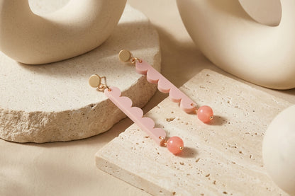 Beige Emma long geometric acrylic earrings in a styled product setting