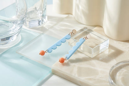 Blue Emma long geometric acrylic earrings in a styled product setting