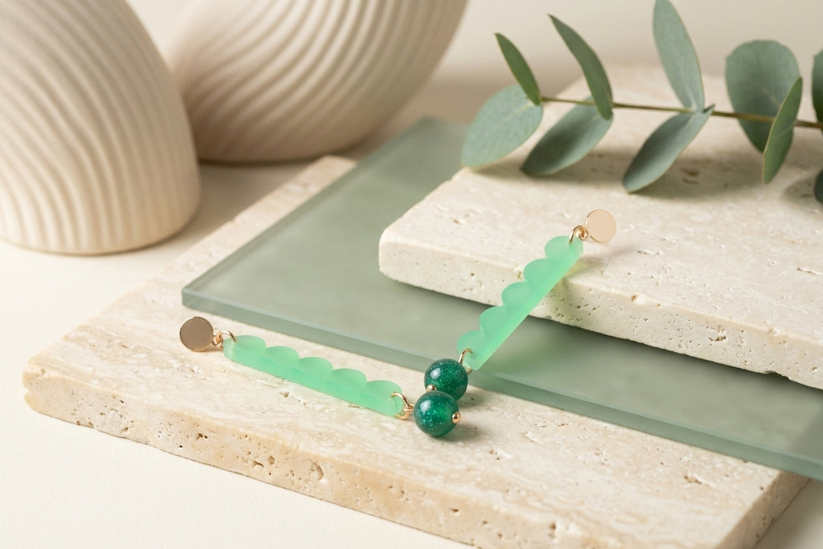 Green Emma long geometric acrylic earrings in a styled product setting