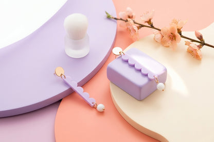 Purple Emma long geometric acrylic earrings in a styled product setting
