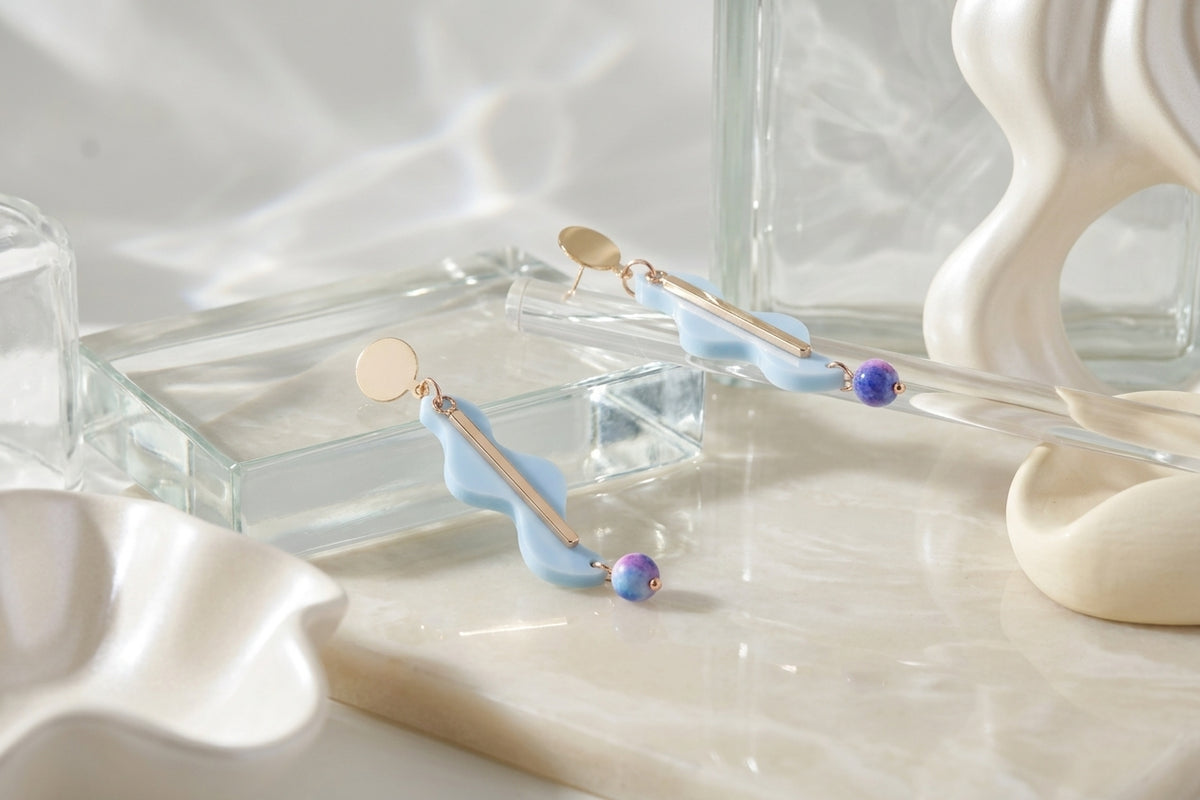 Blue Esme long acrylic statement earrings in a styled product setting