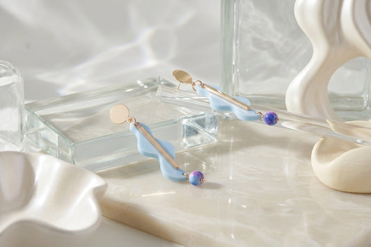 Blue Esme long acrylic statement earrings in a styled product setting