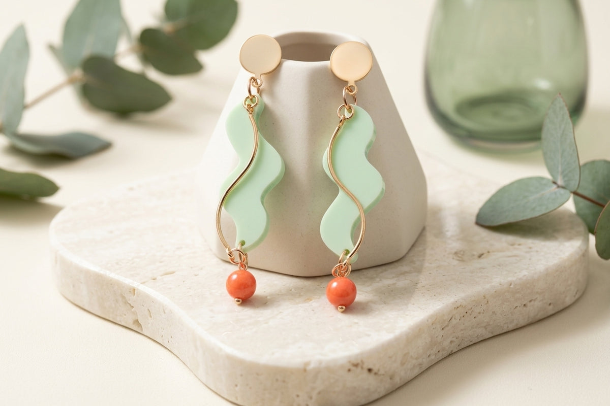 Green Esme long acrylic statement earrings in a styled product setting
