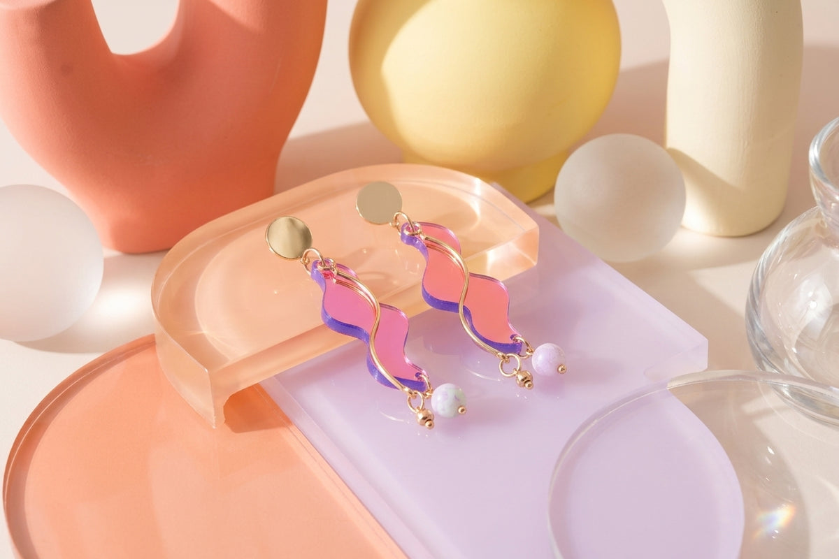 HB Esme long acrylic statement earrings in a styled product setting