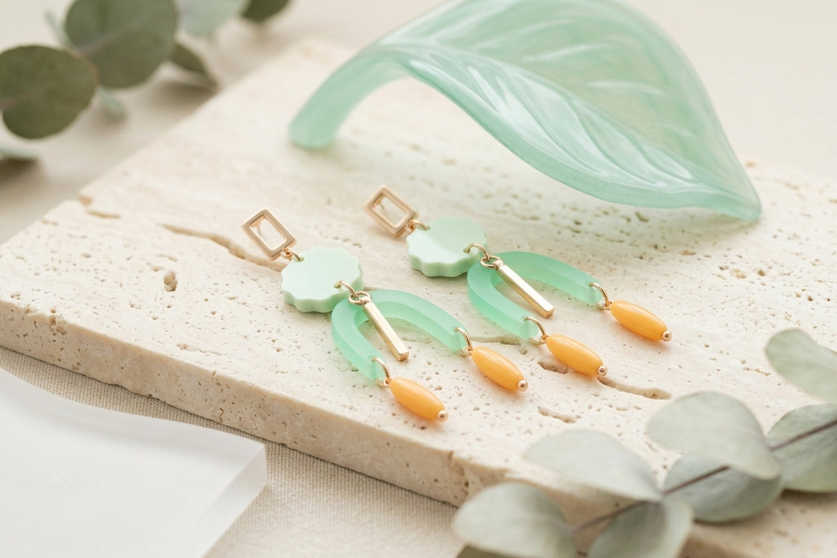Green Eva geometric beaded drop earrings in a styled product setting