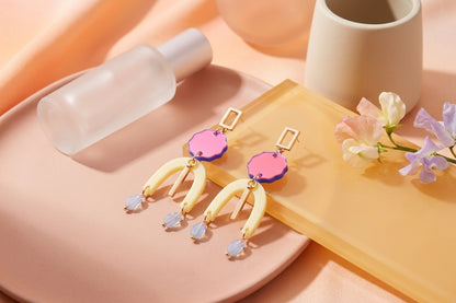 HB Eva geometric beaded drop earrings in a styled product setting