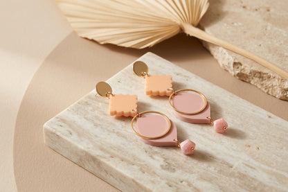 Beige Fien long geometric drop earrings in a styled product setting