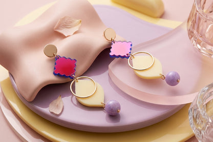 HB Fien long geometric drop earrings in a styled product setting