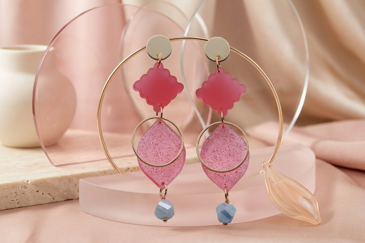 Pink Fien long geometric drop earrings in a styled product setting
