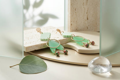 Green Fleur geometric acrylic statement earrings in a styled product setting