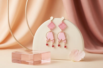 Pink Fleur geometric acrylic statement earrings in a styled product setting