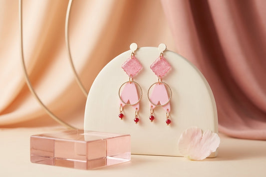 Pink Fleur geometric acrylic statement earrings in a styled product setting