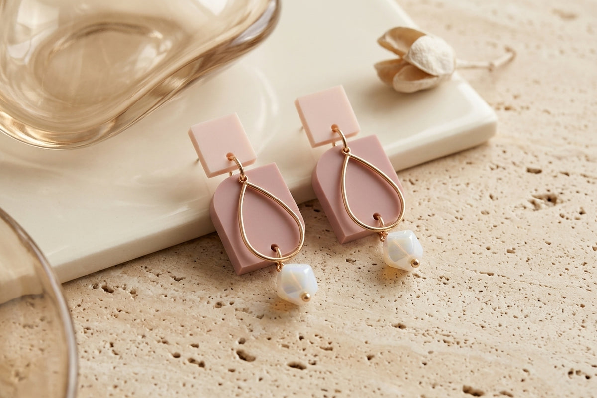 Beige Freya small geometric dangle earrings in a styled product setting