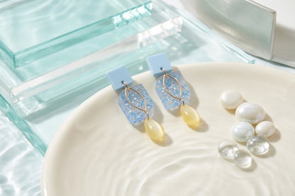 Blue Freya small geometric dangle earrings in a styled product setting