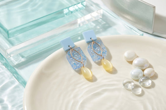 Blue Freya small geometric dangle earrings in a styled product setting