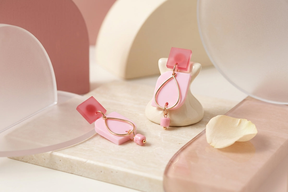 Pink Freya small geometric dangle earrings in a styled product setting