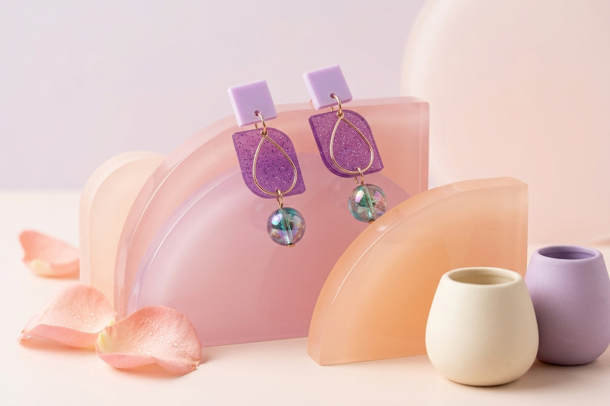 Purple Freya small geometric dangle earrings in a styled product setting