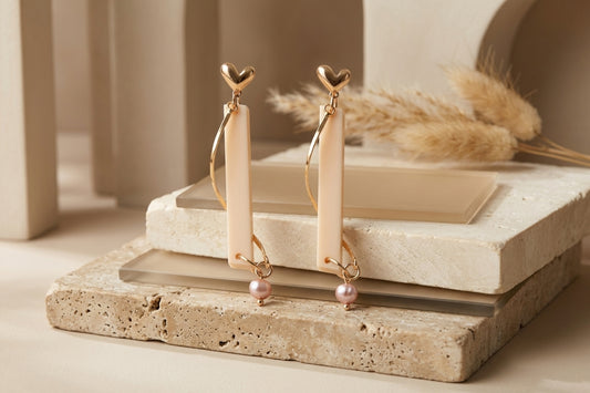 Beige Ina long rectangle acrylic earrings in a styled product setting