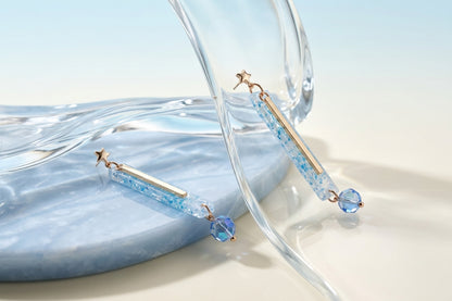Blue Ina long rectangle acrylic earrings in a styled product setting